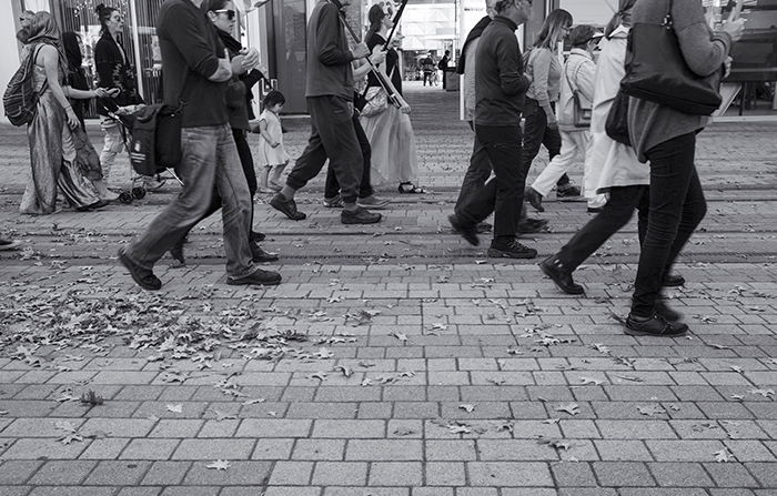 Black and white street photo of a group of people walking. Creative street photography