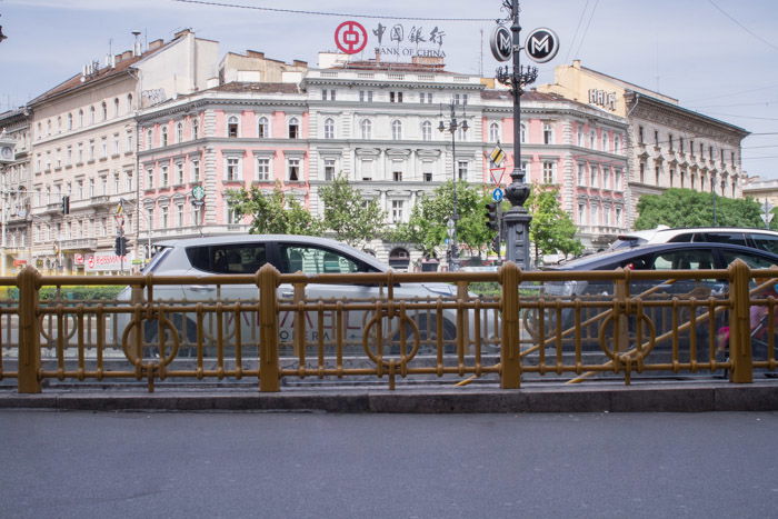 A street scene in Budapest showing cars and buildings but empty of people