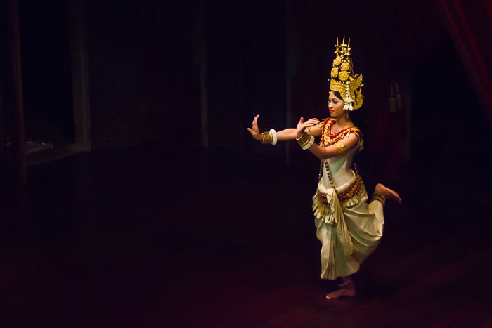 Atmospheric travel photography of a girl dancing in a dimly lit room 