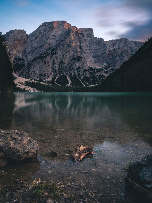 A mountainous landscape surrounding a lake. 