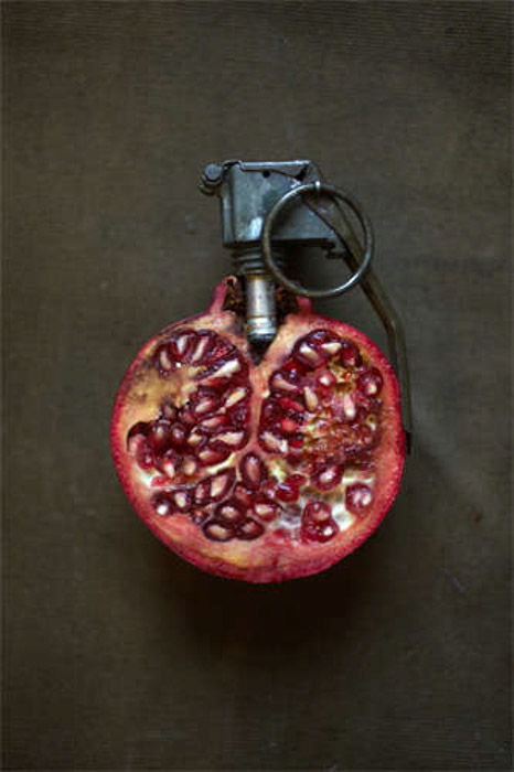 Giuseppe Colarusso still life juxtaposition photography of a pomegranate with grenade pin . Photography juxtaposition examples.