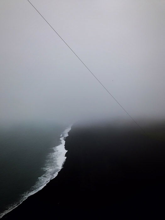 Atmospheric dark image of the coastline juxtaposed by overcast sky