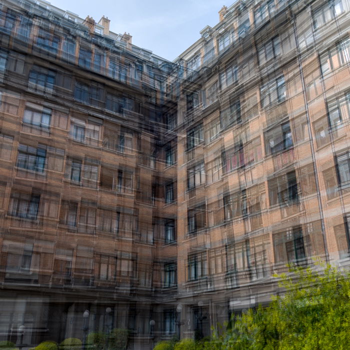 A blurry layered image of a tall apartment building achieved through intentional camera movement and image stacking