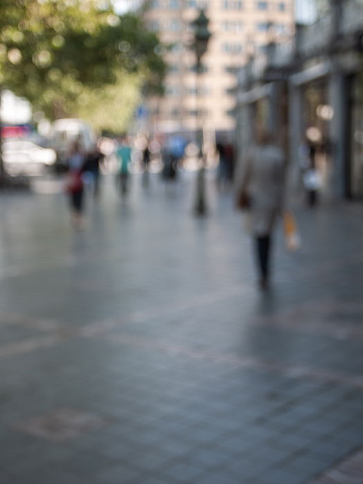 blurry urban street view of people and buildings