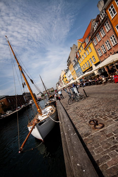 tilted composition photo of the colorful houses, the channel and the restaurants at the Nyhavn canal in Copenhagen 