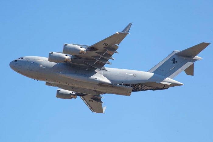 Aviation photography of a flying plane against blue sky - airshow photography tips