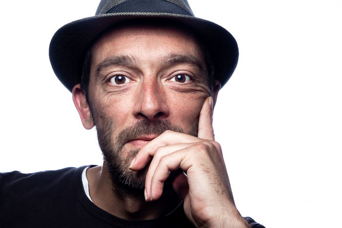 Portrait of brown-eyed man wearing a hat, looking into the camera