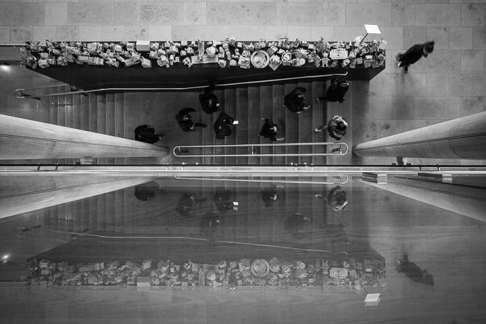 An overhead black and white street photography shot of people walking on outdoor steps