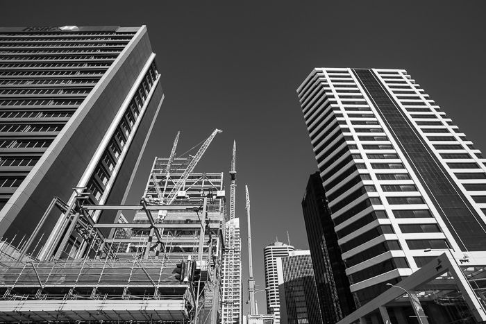 A black and white street photography shot of downtown Auckland, New Zealand on a bright sunny day.