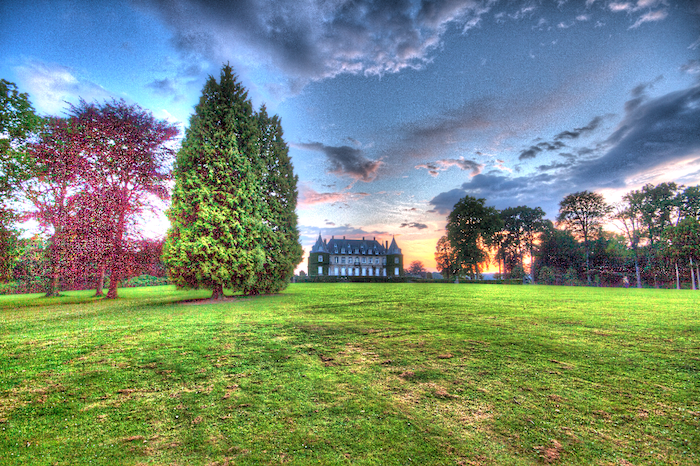 Bright over processed HDR landscape with a castle in the background.