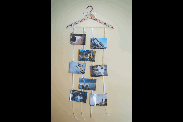 Pictures hanging from a clothes hanger like a mobile as an idea of what to do with photos