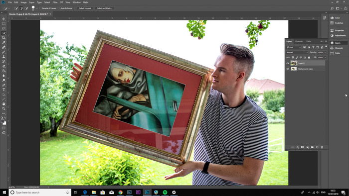 Screenshot of Photoshop editing a photo of a man holding a framed painting - droste-effect step seven