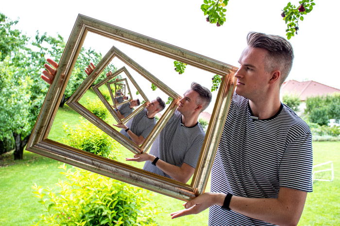 The final droste effect image of a man appearing to hold a photo within a photo within a photo