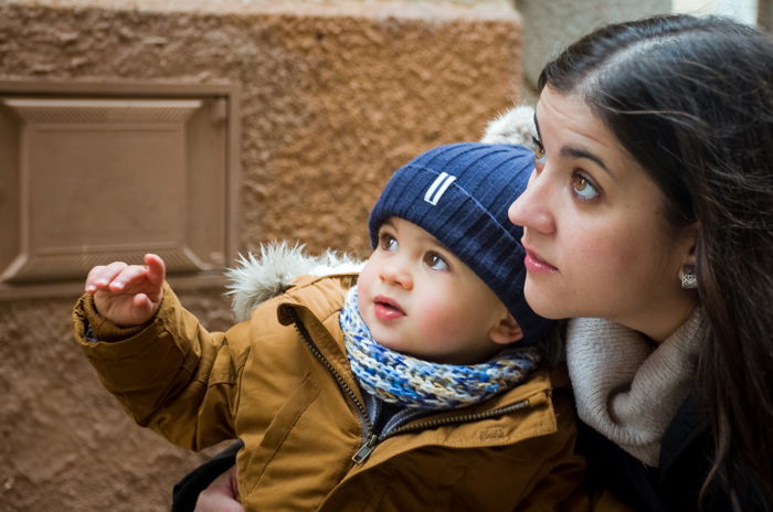 candid style shot of a woman holding a small baby on a beach - family portraits composition