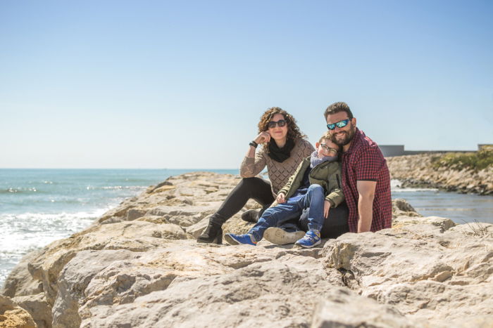 Sweet family portrait photography of a man, woman and child on the beach - family photo ideas