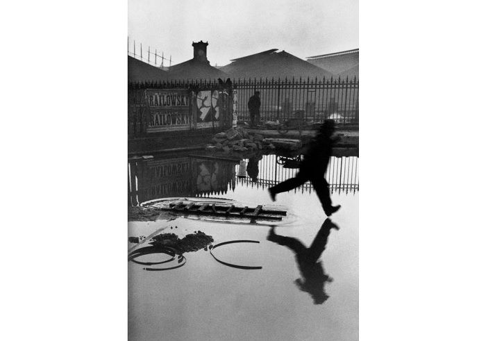 Man striding through puddle. 