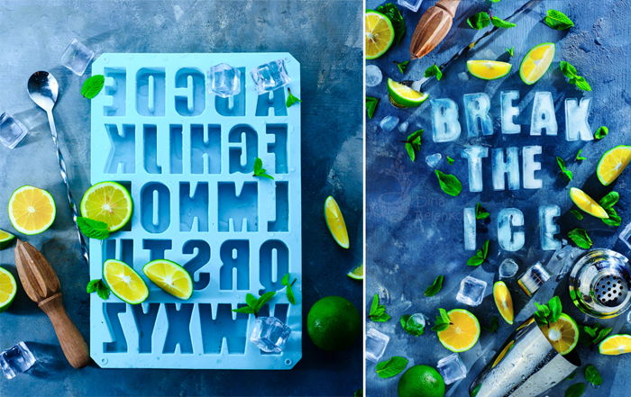 Break the ice concept with cocktail ice, mint, lemons and a bar shaker. Food photography flat lay on a stone background