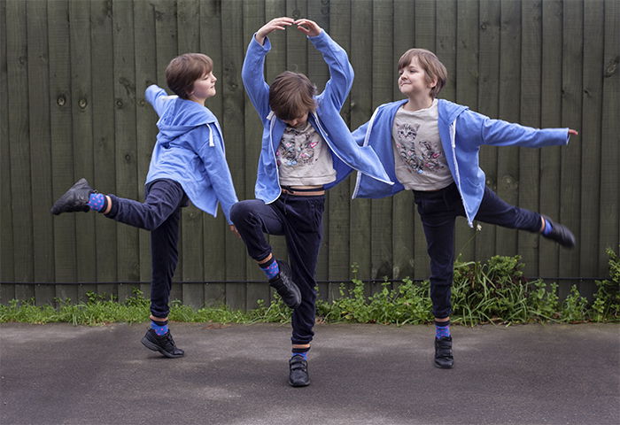 Multiplicity photography example of three of the same little girl dancing outdoors