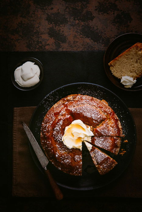 A dark food photography overhead shot of coffee cake with creme fraiche