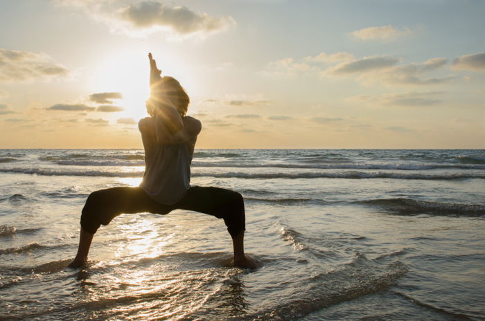 The silhouette of a person posing fro beach photography, a fabulous seascape and sunset in the background