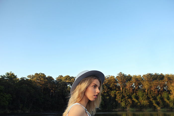 Portrait of a young female model posing in front of a beautiful landscape background