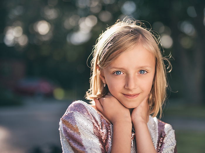 Portrait of a young female model posing with a natural blurry portrait backgrounds