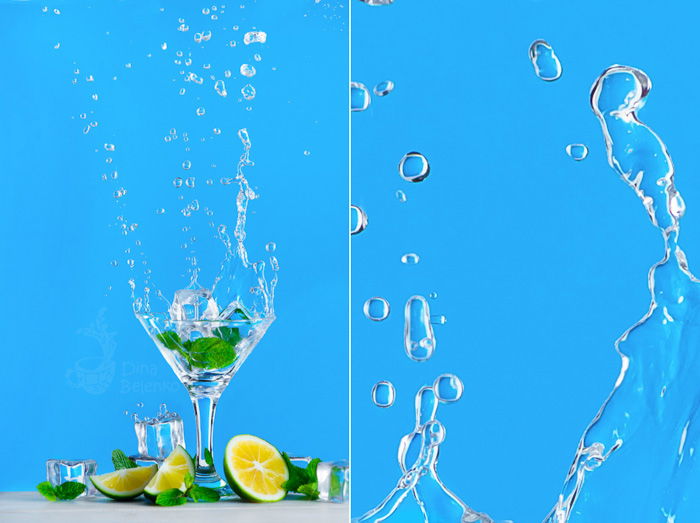 Dynamic water splash photography with a glass of mojito or lemonade on a bright blue background. Refreshing summer drink concept with copy space.