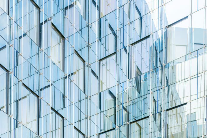 A photo of the exterior of a multi windowed glass building