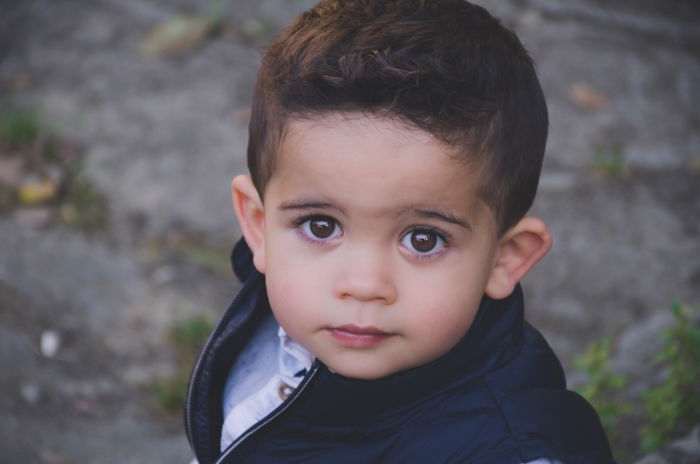 close up headshot of wide eyed boy looking up