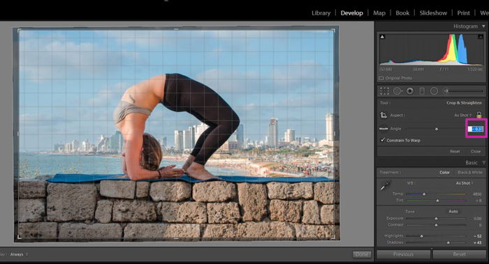 using the grid in lightroom to align a photo of a woman in a yoga pose on a stone brick wall