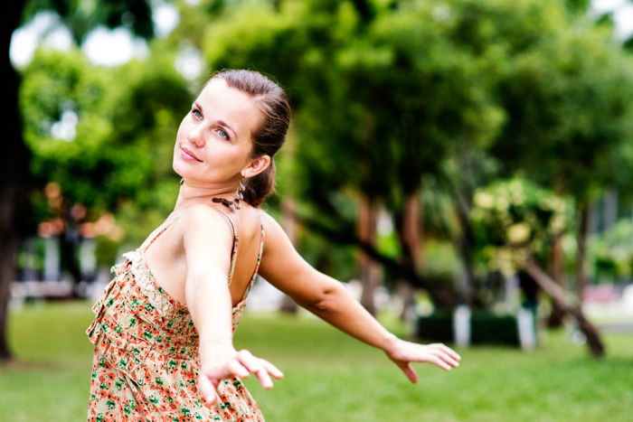 Beautiful young woman in the park enjoying life, example of editorial portrait photography.