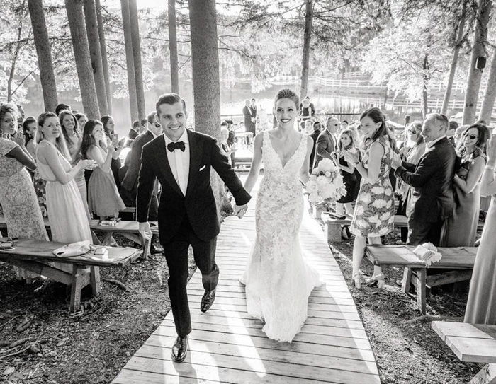 Black and white wedding portrait of the couple walking down the aisle from Heather Waraksa's wedding blog 