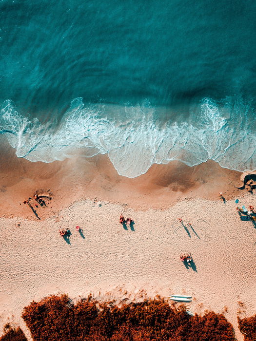 An aerial view of a beach using the color scheme orange and blue