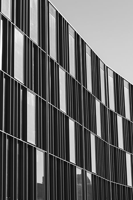 A monochrome photo of a multiwidowed building - best camera settings for black and white photos