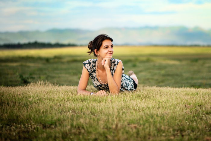 Attractive young woman outdoors in a wide open field at Doi Tao, Thailand.