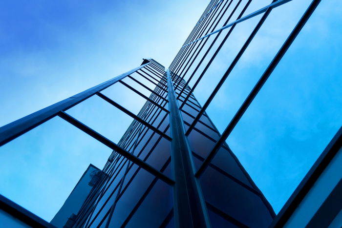 Interesting photo composition of a modern office building on a clear sky background