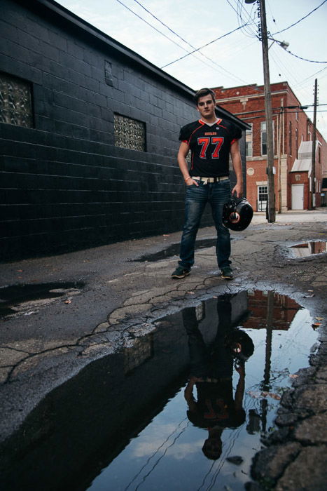 A young man in sports gear posing outdoors 