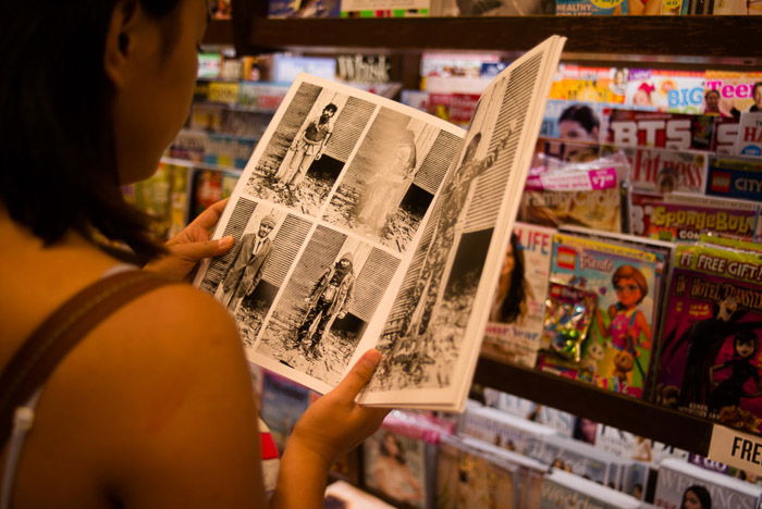 A girl reading a magazine in a shop - magazine photographer tips