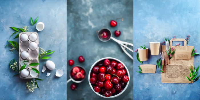 Chicken eggs, whole and broken, in a paper packaging on a concrete background with green leaves and spring flowers. Red cherries in a ceramic bowl, several scattered on the table with small scoops. Eco cooking concept, paper packaging design.