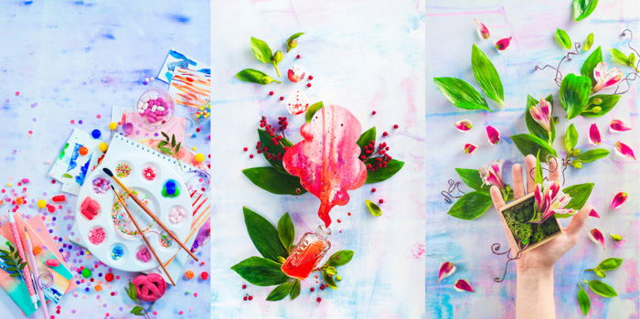 Left: Pink macarons in an artist workplace colorful flat lay with sweets, candies and sprinkles. Painting a dessert with a watercolor pallet filled with hard candies. Middle: large pink petal, paint spilling out of small glass bottle, framed by green leaves on a white paint stained background. Right: Hand holding a small wood box containing a small plant with bright pink flowers; bright pink petals and green leaves scattered on pink and blue paint stained wood background