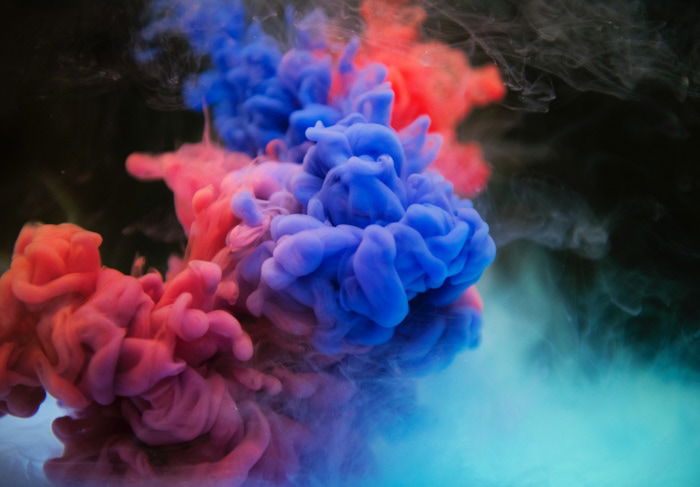 Colorful clouds of smoke against a dark background 