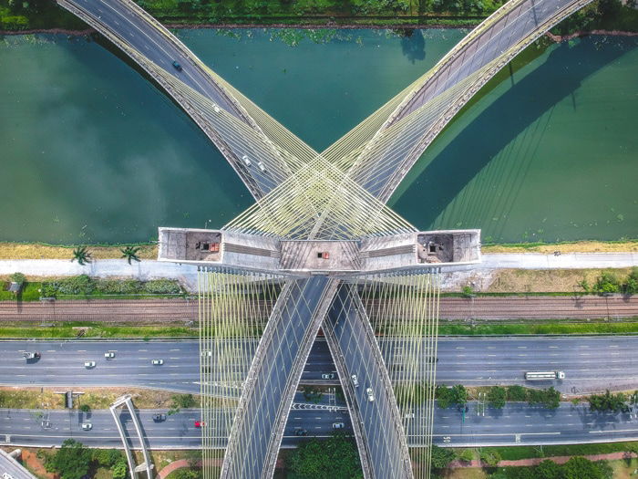 A stunning aerial photograph of traffic on two bridges over a river 