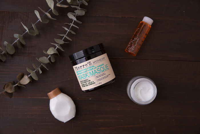 A flat lay shot of cosmetics on a wooden table