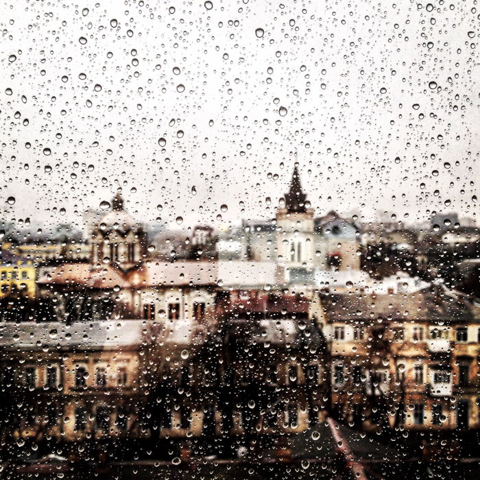 A cityscape seen through a rain-splattered window