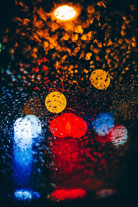 Abstract rain photography shot of colored bokeh lights