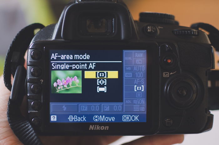 The screen of a Nikon showing AF-area mode autofocus settings to learn DSLR basics