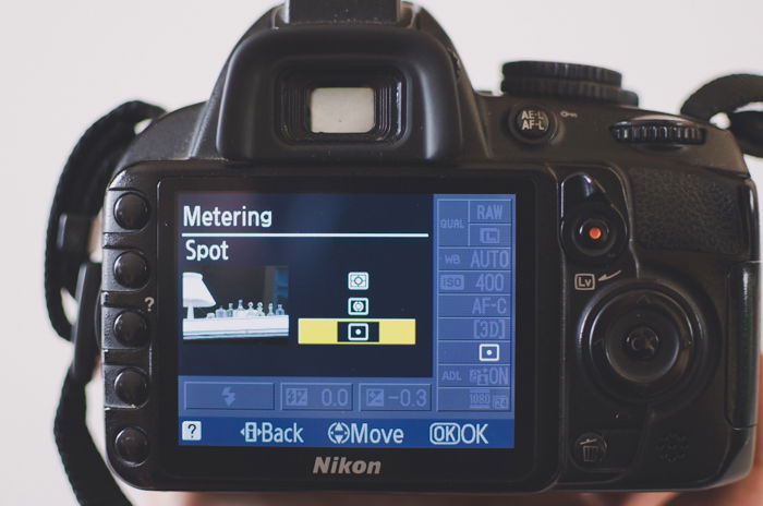 The screen of a Nikon camera showing spot metering camera settings to learn DSLR basics