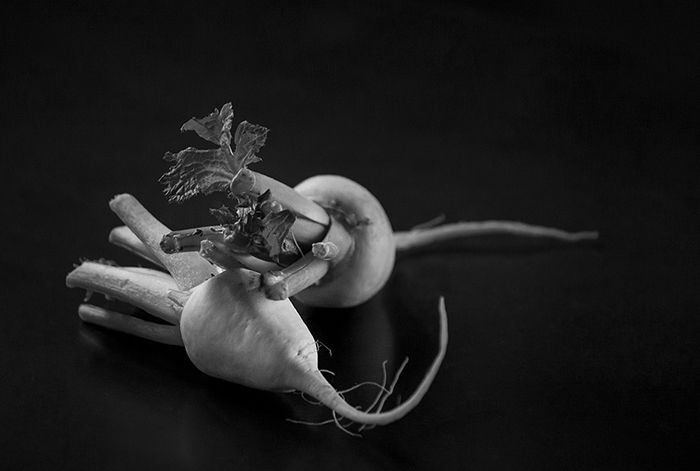 A black and white food still life shot of vegetables