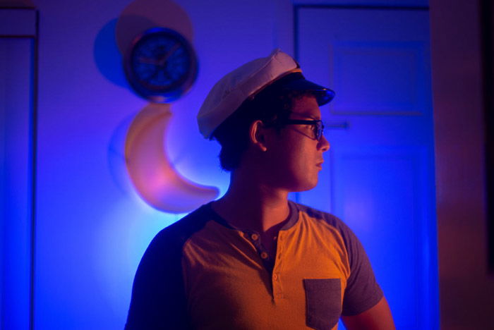 A dramatic blue and orange color gel photography portrait of a male model using lighting gels