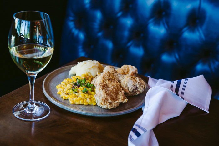 A restaurant photography shoot of a plate of food on a wooden table